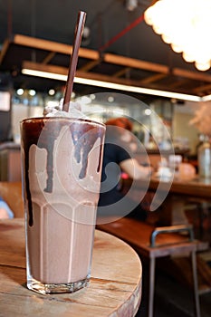 Coco frappe with blurred cafe background photo