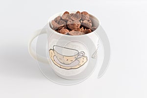 Cocoa cereals in glass on white