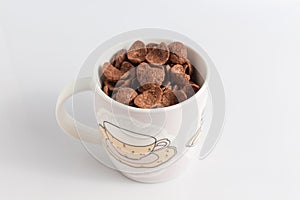 Cocoa cereals in glass on white