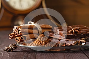 Cocoa and chocolade on wooden table.