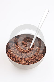 Cocoa coated puffed rice in metal bowl