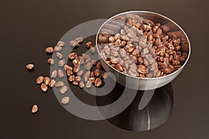 Cocoa coated puffed rice in metal bowl
