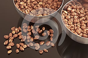 Cocoa coated puffed rice in metal bowls