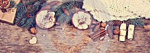 Cocoa, coffee, gift, fir branch, nuts, cones, cozy knitted blanket. Christmas cookies A woman\'s hand holds a cup