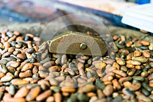 Cocoa concept with raw, peeled, and crushed cocoa beans being roasted traditionally in El Salvador