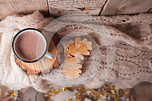 Cocoa with Cozy winter home background, cup of hot cacao, warm knitted sweater on vintage wooden background, vintage tone