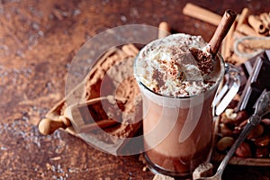 Cocoa with cream, cinnamon, chocolate pieces and various spices
