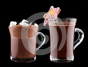 Cocoa with marshmallow, cookies and chocolate syrup in a Cup on a dark background