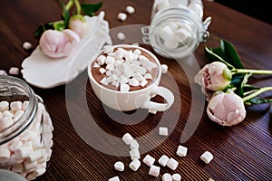 Cocoa with marshmallow and flowers.