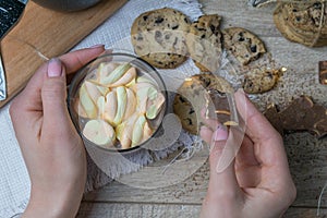 Cocoa with marshmallows and chocolate oven and slices of chocolate stands on a wooden table