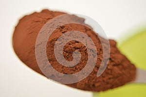 Cocoa on metal spoon macro photos