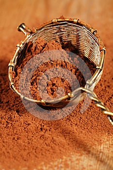 Cocoa powder in old rustic style silver sieve