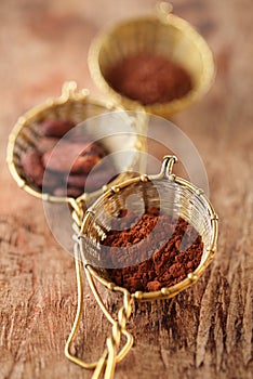 Cocoa powder in old rustic style silver sieves