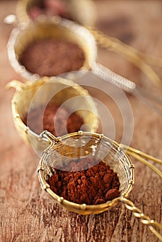 Cocoa powder in old rustic style silver sieves