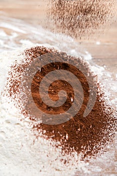 Cocoa powder sifting into white flour, bakery process
