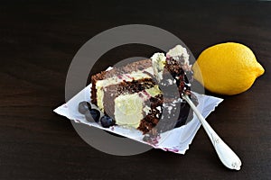 Cocoa sponge cake with lemon cream and blueberry sauce