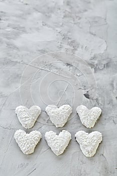 Coconat biscuits arranged in pattern on light textured background, close-up, shallow depth of field, selective focus.