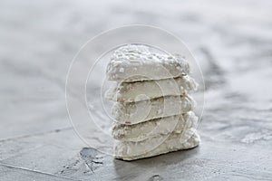 Coconat biscuits arranged in pattern on light textured background, close-up, shallow depth of field, selective focus.