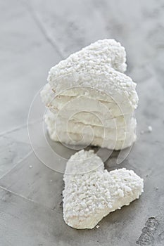 Coconat biscuits arranged in pattern on light textured background, close-up, shallow depth of field, selective focus.