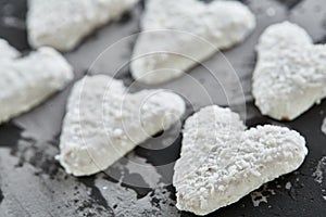 Coconat biscuits arranged in pattern on light textured background, close-up, shallow depth of field, selective focus.