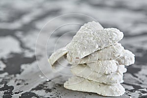 Coconat biscuits arranged in pattern on light textured background, close-up, shallow depth of field, selective focus.