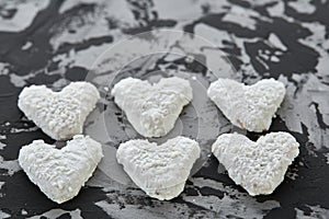 Coconat biscuits arranged in pattern on light textured background, close-up, shallow depth of field, selective focus.