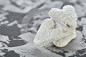 Coconat biscuits arranged in pattern on light textured background, close-up, shallow depth of field, selective focus.