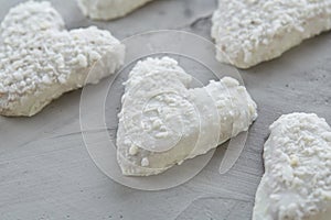 Coconat biscuits arranged in pattern on light textured background, close-up, shallow depth of field, selective focus.