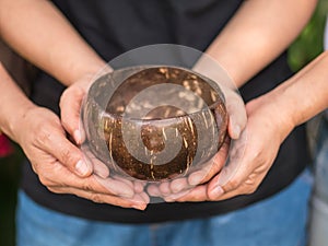 Coconut bowl on hands