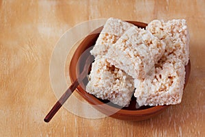 Coconut candy cocada on brown plate