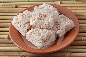 Coconut candy cocada on brown plate