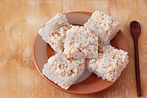 Coconut candy cocada on brown plate