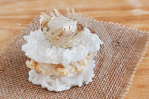 Coconut candy cocada with wicker hat on sackcloth