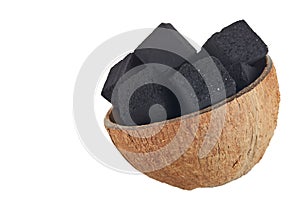 Coconut charcoal on a white background. Coconut coal cubes for hookah and coconut close-up. Copy space.