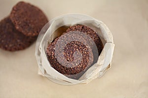 Coconut chocolate cookies in brown paper bag