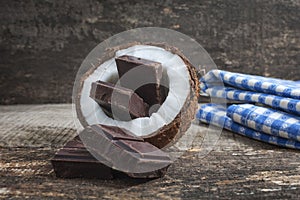 Coconut with chocolate on wooden background