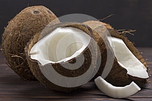 Coconut, chopped in half coconut on dark wooden background