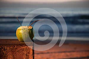 Coconut cocktail on a background sunset .