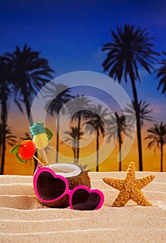 Coconut cocktail on tropical sand beach heart sunglasses