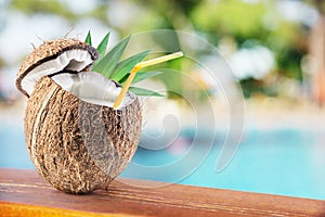 Coconut with cocnut milk on the bar table.