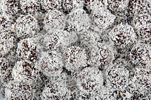 Coconut and cocoa happiness balls. Rum balls in coconut. Traditional unbaked Czech sweets for Christmas and winter. Raw sweet food