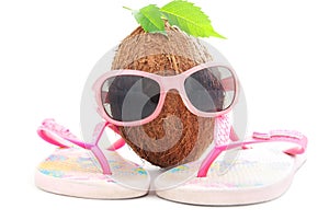 Coconut concept with sunglasses and beachwear