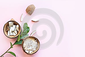 Coconut cut into pieces, coconut shavings on a pink background. View from above. Place for text