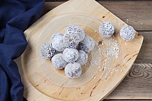 Coconut energy balls on a wooden tray