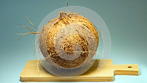 Coconut, exotic fruit, fruit in the shell on a wooden board, series background, selective focus, close-up