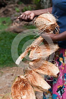 Coconut in female hands with removed shell