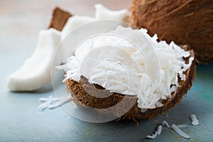 Coconut flakes in a shell on a blue background