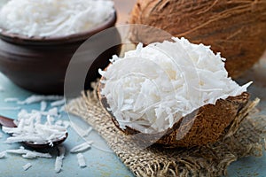 Coconut flakes in a shell on a blue background