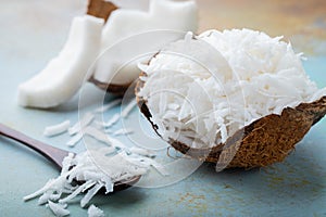 Coconut flakes in a shell on a blue background