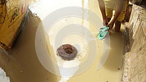 Coconut floats in dirty water little indian boy stays in river Ganges and begins to play with it